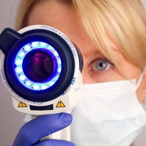 Dentist performing oral cancer screening