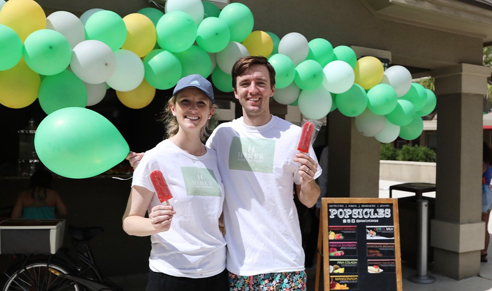 Doctors Matt and Reagan Hiner eating treats at a community event