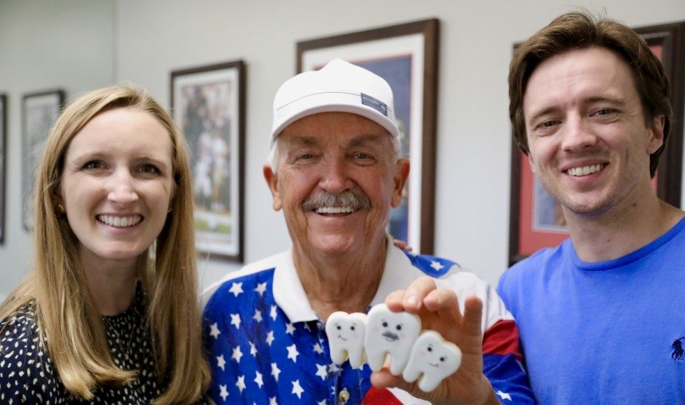 Doctor Reagan and Matt Hiner and smiling dental patient