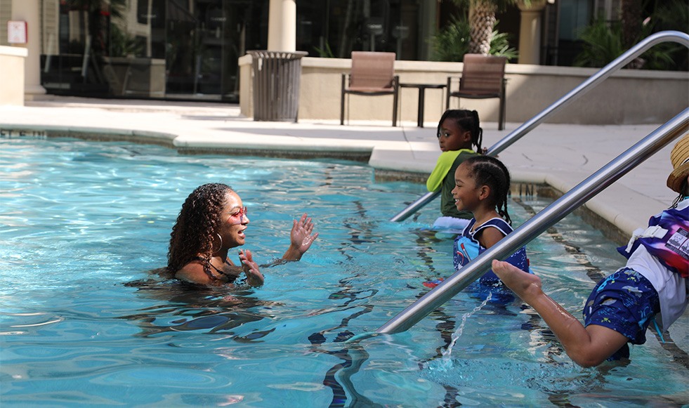 Dental team members and kids at the pool