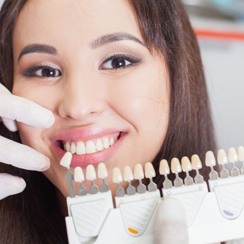 Woman's smile compared with cosmetic dental bonding shade options