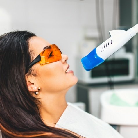 Woman receiving in office professional teeth whitening