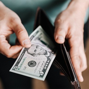 Man pulling cash out of a wallet