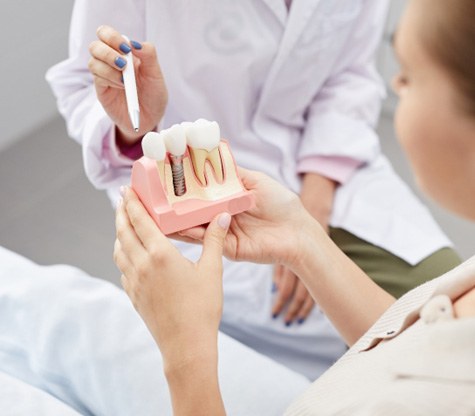 dentist explaining dental implant to patients