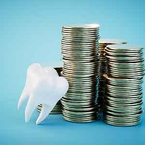 Tooth propped against stacks of quarters