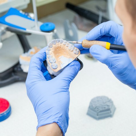 Lab technician carving dentures