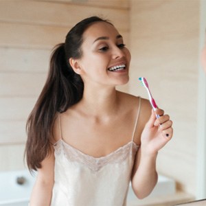 Woman smiling with a toothbrush