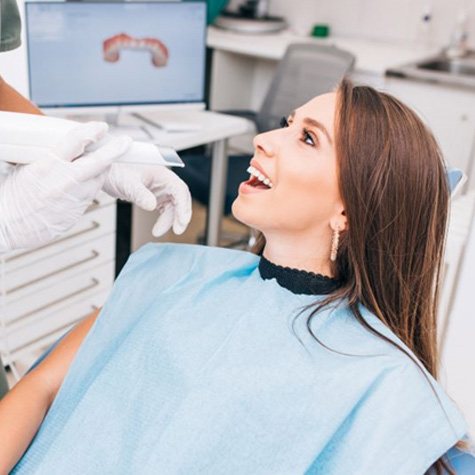 Dentist preparing to use digital impression scanner on patient