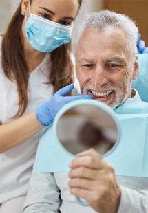 man smiling in dental mirror 