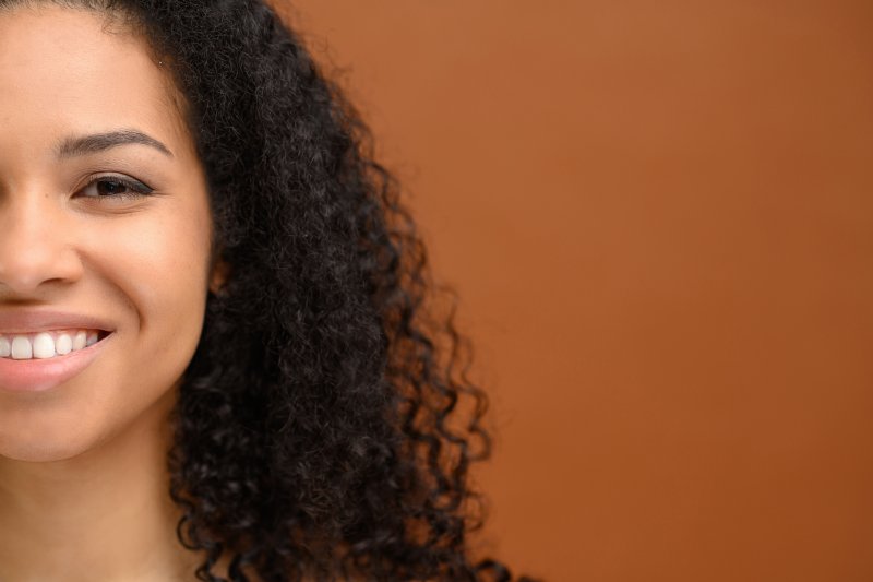 A woman smiling with her new cosmetic dentistry treatments