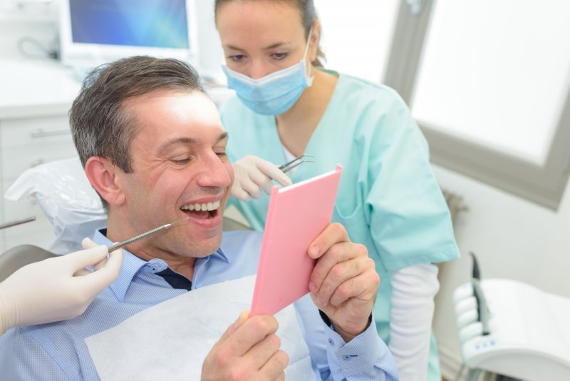 Man smiling with his newly refreshed dental veneers